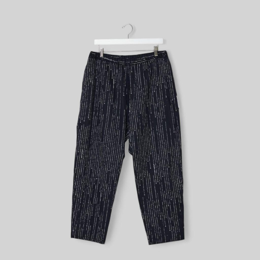 still life image of The Stardust stripes pants by GoodNeighbors Shirts; dark navy cotton pants with white hand-chalk dran stripe created by the designer himself.