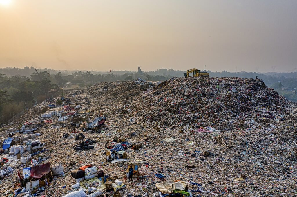 Huge landfill of textile waste questioning whether the French fast fashion law actually addresses the problem